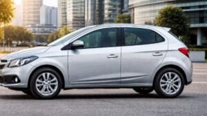 Chevrolet Onix 2015 prata visto de perfil com lateral completa em ambiente urbano moderno