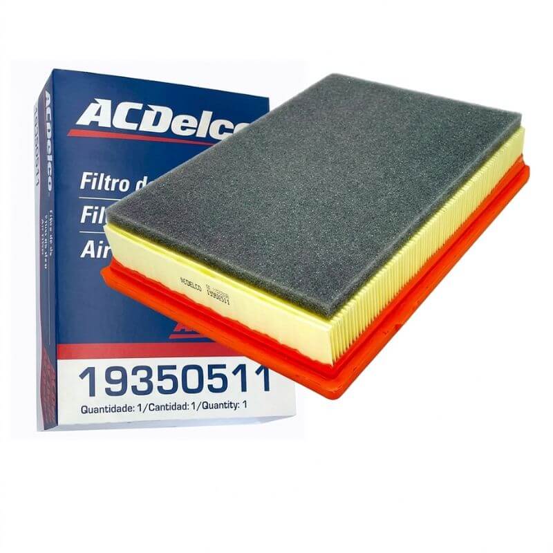 Filtro de ar do motor ACDelco para Chevrolet Onix (código 19350511) com camada superior de espuma cinza, papel filtrante amarelo e base de borracha laranja, posicionado ao lado de sua embalagem original azul e branca.